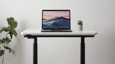 A sleek modern workspace featuring a laptop on a minimal desk with a small indoor plant, perfect for enhancing productivity and creativity in a stylish environment.の素材