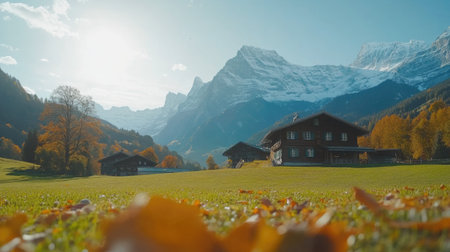 A picturesque view of traditional Swiss chalets nestled in a serene mountain landscape during autumn. The vibrant foliage and majestic peaks create a tranquil atmosphere, perfect for a getaway.の素材