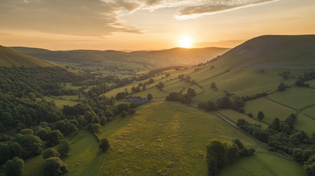 A breathtaking aerial view capturing the serene beauty of rolling hills and lush valleys at sunrise, showcasing the tranquility of rural landscapes.の素材