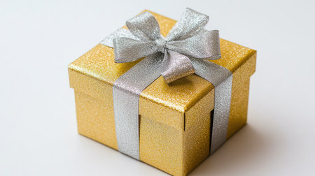 A stunning golden gift box adorned with a silver ribbon, perfect for any celebration. This elegant present adds a touch of luxury and joy to special occasions.の素材