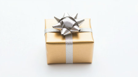 A beautifully wrapped golden present box adorned with a shiny silver ribbon and bow, set against a clean white background, perfect for any festive occasion.の素材