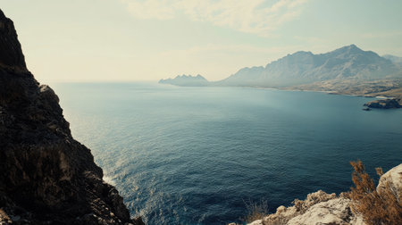 A breathtaking view of a serene coastal landscape showcasing mountains and calm ocean waters. The scene captures nature's beauty and tranquility in stunning detail.の素材