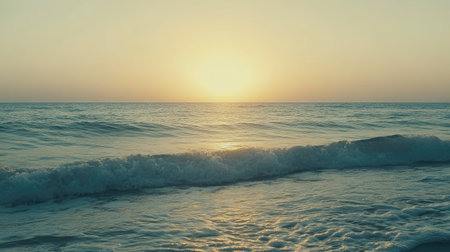 Experience the calm beauty of a serene sunrise over gentle ocean waves, capturing the essence of tranquility and natural splendor at the beachside.の素材