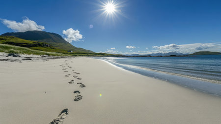 A serene beach scene showcasing gentle footprints on soft sand under a bright sun. The calm water reflects the vibrant blue sky, inviting relaxation.の素材
