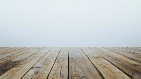 A rustic wooden plank floor creates a warm, inviting surface against a soft white background. This image embodies minimalism and natural beauty, perfect for various creative projects.の素材