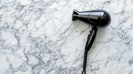 A sleek black hair dryer rests on a smooth white marble surface, perfect for beauty and fashion themes, showcasing elegance in home styling.の素材