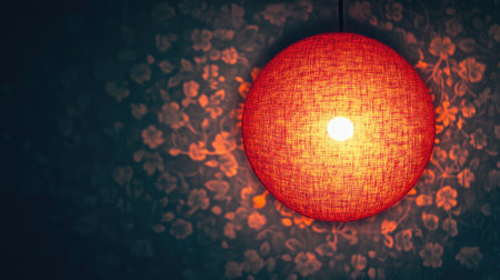 A warm red lamp hangs gracefully, casting soft light onto a floral patterned wall, creating a cozy and inviting atmosphere perfect for relaxation.の素材