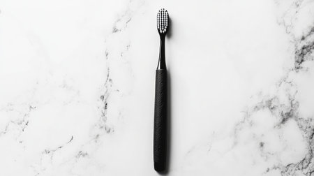 This image features a minimalist black toothbrush placed on a white marble surface, emphasizing elegance and simplicity in dental care. Perfect for personal care themes.の素材