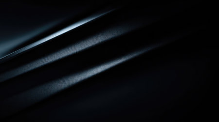 This image features an elegant dark fabric texture with smooth waves and soft light rays. The luxurious and mysterious atmosphere is perfect for various design projects.の素材
