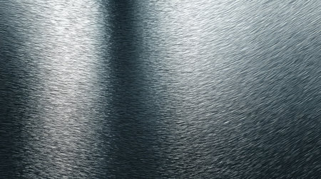 This image features a smooth silver metal surface with a subtle brushed texture, ideal for backgrounds in industrial and technology-related design projects or modern aesthetics.の素材