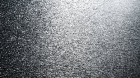 A captivating textured metallic surface featuring subtle reflections and shimmering light effects, ideal for creative designs, backgrounds, and abstract artwork.の素材