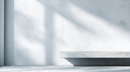A minimalist white room featuring a smooth surface and soft shadows, creating an airy space perfect for showcasing art, furniture, or design elements.の素材