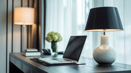 A modern workspace featuring a sleek laptop, a stylish lamp, and elegant decor creates a cozy atmosphere for creativity and productivity in a bright room.の素材