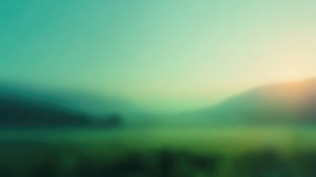 Ethereal landscape showcasing soft fog and gentle sunrise illuminating rolling hills and vibrant green fields, creating a tranquil and serene atmosphere.の素材