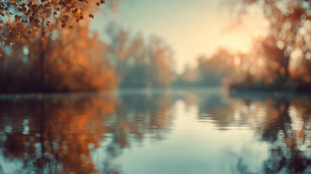 A serene autumn landscape showcases colorful foliage surrounding a calm body of water, reflecting warm sunlight in a tranquil and picturesque nature setting.の素材