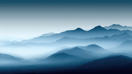 This beautiful mountain landscape showcases layers of blue misty peaks under a soft gradient sky. It evokes feelings of tranquility and peacefulness, ideal for nature themes.の素材