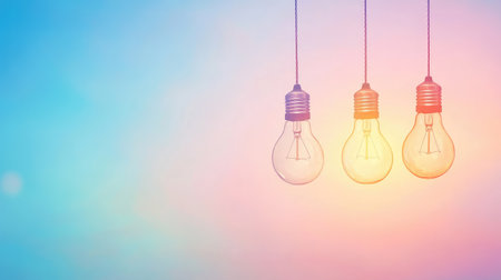 Three light bulbs are suspended against a softly blended color background, creating a serene and inviting vibe. Ideal for design and decoration projects.の素材