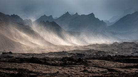 A captivating view of a rugged volcanic landscape featuring mist and dramatic mountain silhouettes under a moody cloudy sky, ideal for exploration themes.の素材