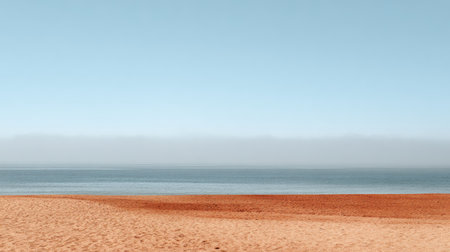 This serene seascape features a peaceful beach with soft sand and calm waters under a clear blue sky, ideal for conveying relaxation, tranquility, and nature's beauty.の素材