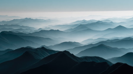 Explore a breathtaking mountain landscape characterized by soft rolling hills enveloped in fog. This serene scene captures the essence of nature's tranquility and beauty.の素材