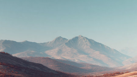 An awe-inspiring view of majestic mountains under a clear blue sky, showcasing the breathtaking beauty and tranquility of nature, perfect for travel and adventure themes.の素材