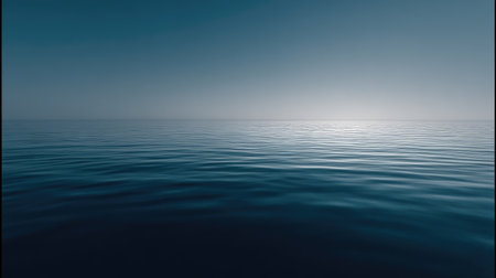 This image captures a tranquil ocean horizon at dawn, featuring soft blue tones and gentle waves, creating a peaceful and serene atmosphere perfect for relaxation.の素材