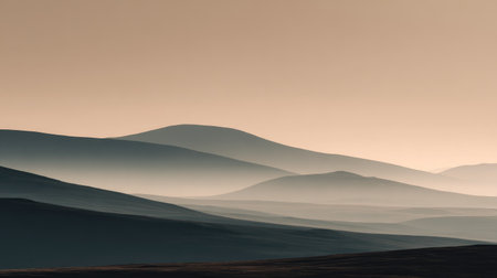 A tranquil view of rolling hills softly fading into the horizon during dawn, showcasing serene colors and gentle silhouettes perfect for nature-themed projects.の素材