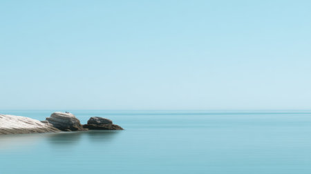 Experience a tranquil coastal landscape featuring smooth water and a calm horizon under a clear blue sky, creating a perfect serene setting for relaxation and meditation.の素材
