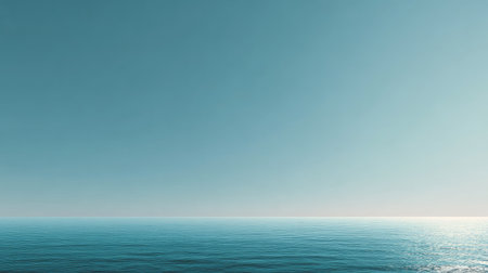 Experience the serene beauty of an expansive ocean horizon under a clear blue sky. This peaceful landscape creates a perfect backdrop for relaxation and tranquility.の素材