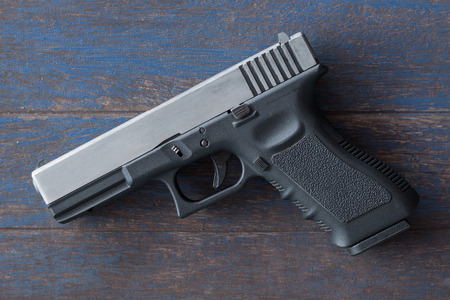 Gun on wooden background