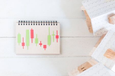 Property investment, Candlestick chart make from color paper Green and red on paper notebook,...