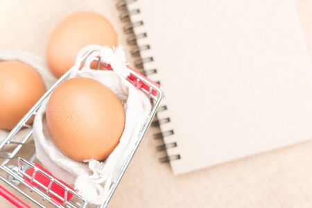 Eggs in red cart with brown paper blank