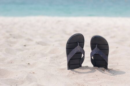 sandals on the sandy with Beautiful beach Backgroundの写真素材