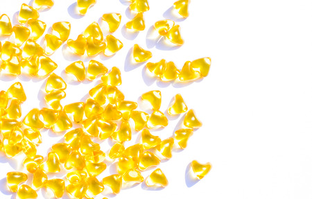 Golden heart color pills of fish oil for healthy and for a gift of valentines dayの写真素材