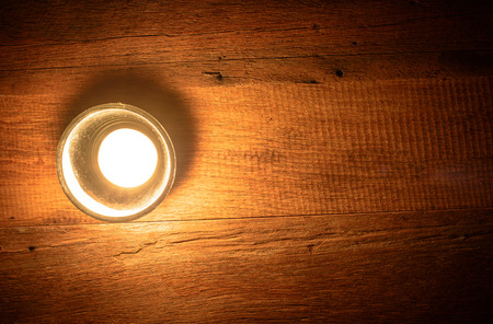 Romantic time with candle of light put on a wooden tableの写真素材