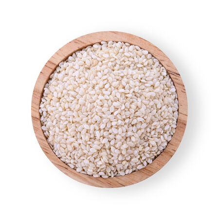 White sesame seeds in a wooden cup isolated on a white background. Top viewの写真素材