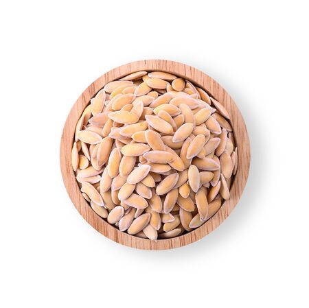 Melon seeds in a wooden cup Isolated on a white background.の写真素材