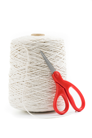 roll of white rope isolated with red scissorsの写真素材