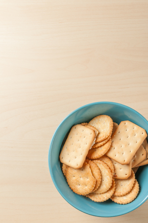 crackers cheese and crackers sugar in color bowl on wood table, toned pictureの写真素材