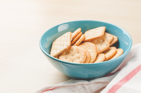 crackers cheese and crackers sugar in color bowl on wood table, toned pictureの写真素材