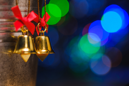christmas bells decorations with background of bokeh blurred lighting, low key pictureの写真素材