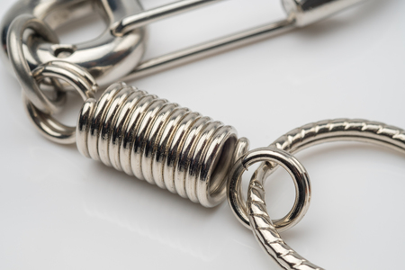 silver coil spring of carabiner keychain or keyring on white backgroundの写真素材