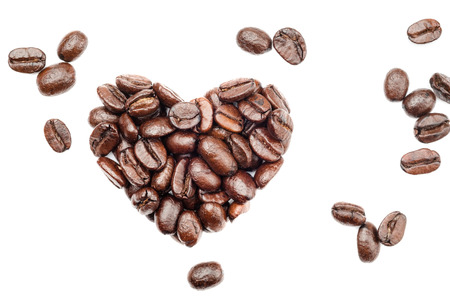 Coffee beans in heart shape isolated on white backgroundの写真素材