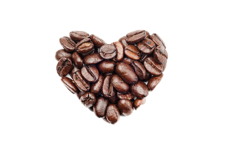 Coffee beans in heart shape isolated on white backgroundの写真素材