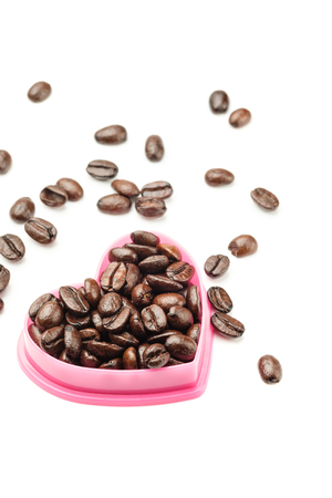 Coffee beans in heart shape isolated on white backgroundの写真素材