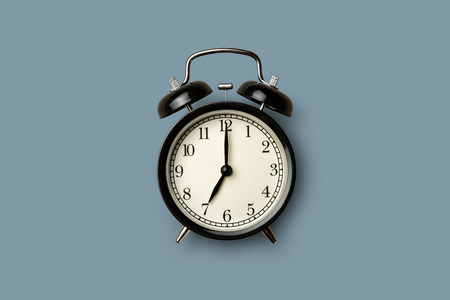 black vintage alarm clock on gray color backgroundの写真素材