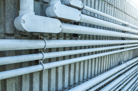 electrical conduit on concrete wall in cold tone pictureの写真素材