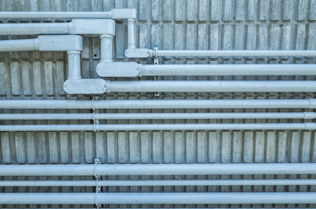 electrical conduit on concrete wall in cold tone pictureの写真素材