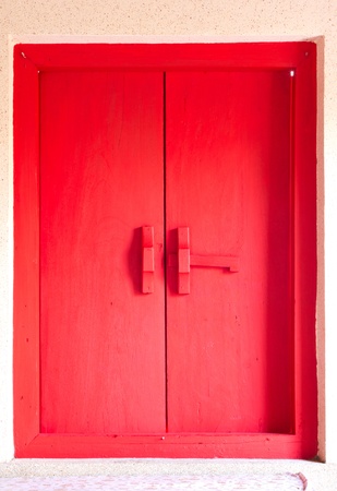 Thai style red window in thai templeの写真素材