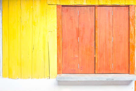 wooden window and yellow panel wallの写真素材